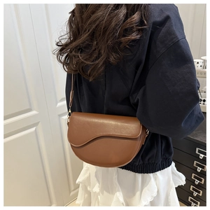 Brown faux leather saddle bag worn by a model showing back view and daily styling