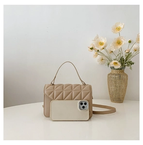Quilted beige handbag size comparison with a smartphone on a white surface