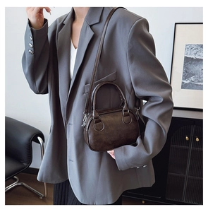 Close-up of retro brown shoulder bag featuring embossed LUCKY OUTD CHINA text