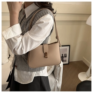 Chic beige PU leather underarm bag featuring a vintage bronze buckle and knotted strap detail