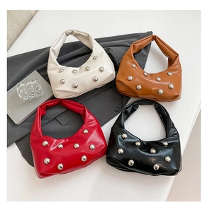 Flat lay of chic leather shoulder bags with silver rivets in white, brown, red, and black