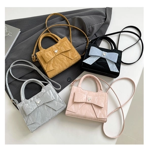 Collage of chic bow handbags in four colors featuring glossy wrinkled leather and heart buckle