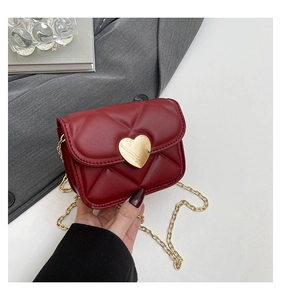 Detail of red quilted leather mini bag with gold heart lock and chain strap