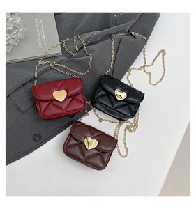 Detailed view of quilted leather crossbody bags with heart-shaped gold clasps in three colors