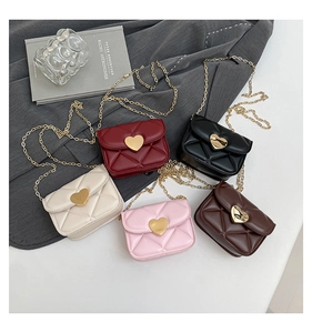 Detail showing various colors of quilted mini bags with heart buckles and gold chains