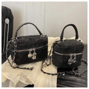 Detail of quilted leather mini bags with floral charms and metal chain straps