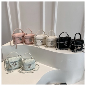 Quilted vanity bags in pink, beige, black, and mint with chain straps on display