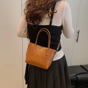 Minimalist large brown tote bag in vintage faux leather shown on a model for daily commute