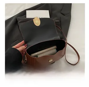 Detail view of brown vintage saddle bag interior showing space for phone and wallet