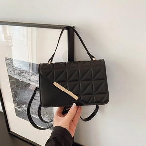 Black quilted crossbody bag with gold buckle and triangle stitching for women