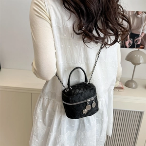 Chic black quilted velvet chain crossbody bag worn by a model in a modern interior