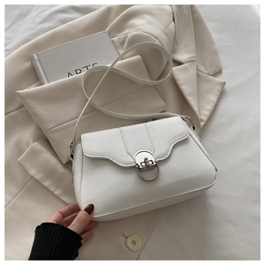 Detail of white matte leather shoulder bag with wave flap and silver metal buckle