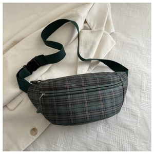 Detail of retro plaid waist bag with adjustable strap and green textured fabric