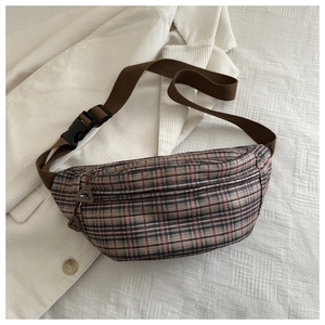 Detail of coffee plaid waist bag with adjustable woven strap and metal zipper hardware