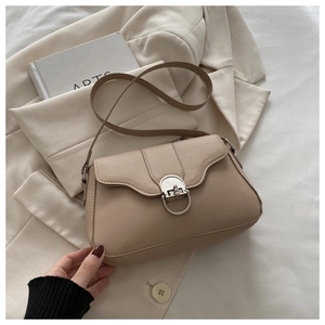 Detail of oat-beige PU leather crossbody bag featuring silver semi-circle metal buckle
