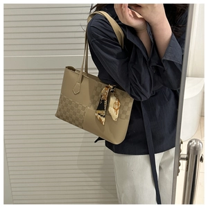 Detail of tan tote bag with checkerboard patchwork and elegant floral silk scarf wrap