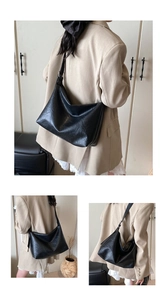 Close-up of black soft leather shoulder bag with natural texture and large capacity