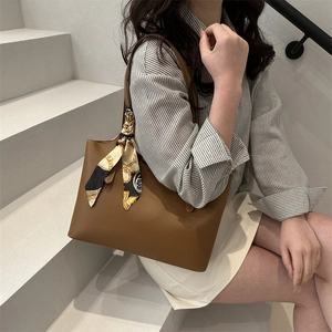 Vintage brown soft leather tote bag for women with a decorative silk scarf on strap