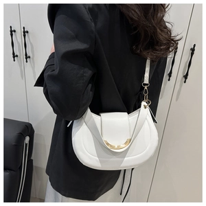 Close-up of white leather crescent shoulder bag featuring a minimalist gold crescent metal buckle