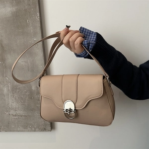 Minimalist beige leather crossbody bag with silver metal buckle closure for women