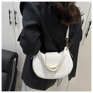 Detail of white half-moon crossbody bag with gold metal buckle and sleek polished finish