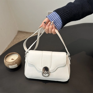 Minimalist white leather shoulder bag with silver turn-lock clasp for daily commute