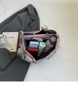 Spacious interior of silver tote bag showing capacity for tablet, phone and essentials
