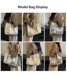 Model display of large tote bags in beige and silver with pink bows and heart studs