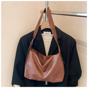 Detailed texture of brown faux leather hobo bag styled with a minimalist outfit