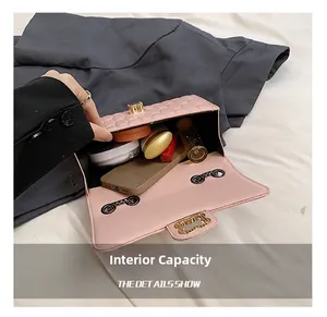 Pink quilted leather crossbody bag open showing interior storage for phone and makeup