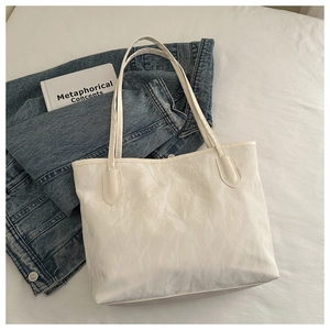 Close-up of white tote bag with unique crinkled texture and minimalist paper-like style