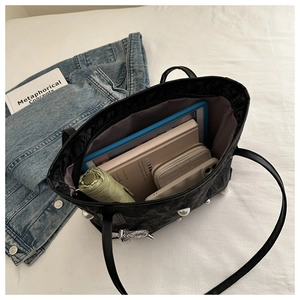 Detailed interior view of a large tote bag holding an umbrella, tablet, and wallet