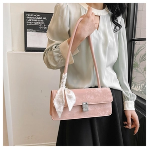 Pink matte shoulder bag with a silver rhinestone buckle and elegant silk scarf detail