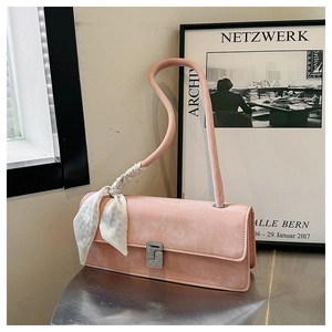 Detail of pink faux suede shoulder bag with silk scarf handle and diamond square buckle