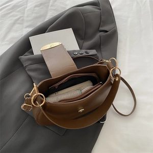 Minimalist dark brown half-moon hobo bag with gold hardware and layered interior