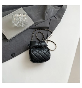 Close-up of black quilted PU leather crossbody bag featuring a large decorative bow