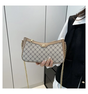 Detail of vintage monogram shoulder bag with gold floral clasp and chain strap