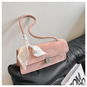 Detail of pink faux suede shoulder bag with silk scarf and crystal encrusted buckle