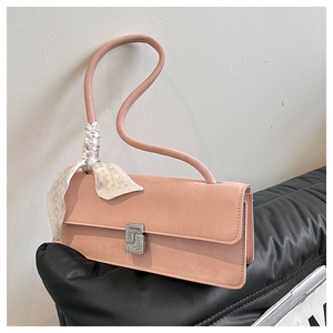 Detail of pink suede shoulder bag with silk scarf handle and silver square clasp