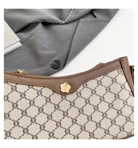Detail of vintage geometric print handbag with brown leather trim and golden hardware