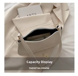 Internal capacity view of off-white crocodile embossed shoulder bag with essentials