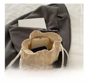 Top view of beige woven bucket bag showing interior space for phone and wallet