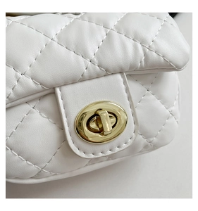 Macro shot of white quilted leather texture and premium gold turn-lock buckle detail