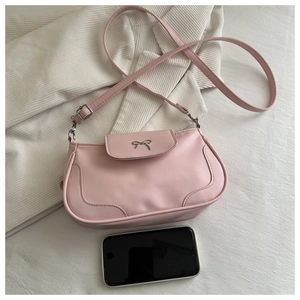 Detailed top view of pink PU leather square bag with bow and phone for size reference