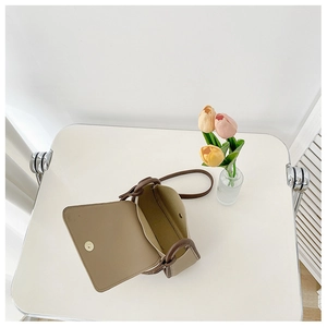 Detailed top view of beige small square bag showing magnetic closure and interior