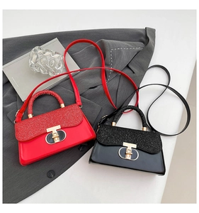 Detailed view of polished handbags with glitter flap and golden T-shaped metal clasp