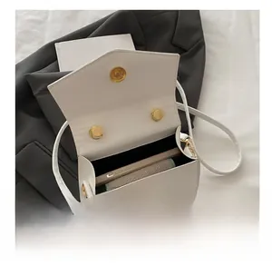 Interior view of white crossbody bag with magnetic closure showing daily storage space