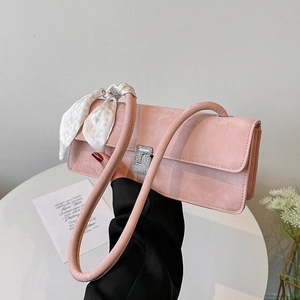 Pink faux suede shoulder bag with rhinestone buckle and floral silk scarf on handle