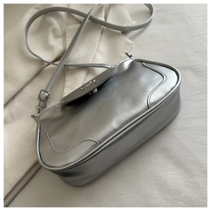 Detail of silver square bag featuring matte metallic PU leather and fine side stitching