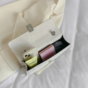 White minimalist flap shoulder bag with silk scarf showing spacious interior with essentials